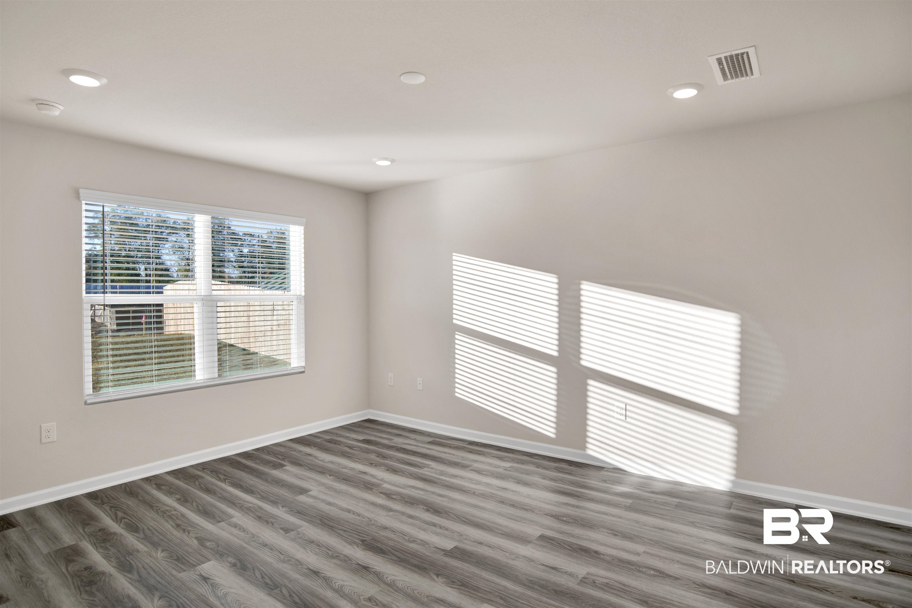 32038 Lyon Road Daphne, AL 36527 - Photo 21 of 30 Spare room with dark wood finished floors and recessed lighting