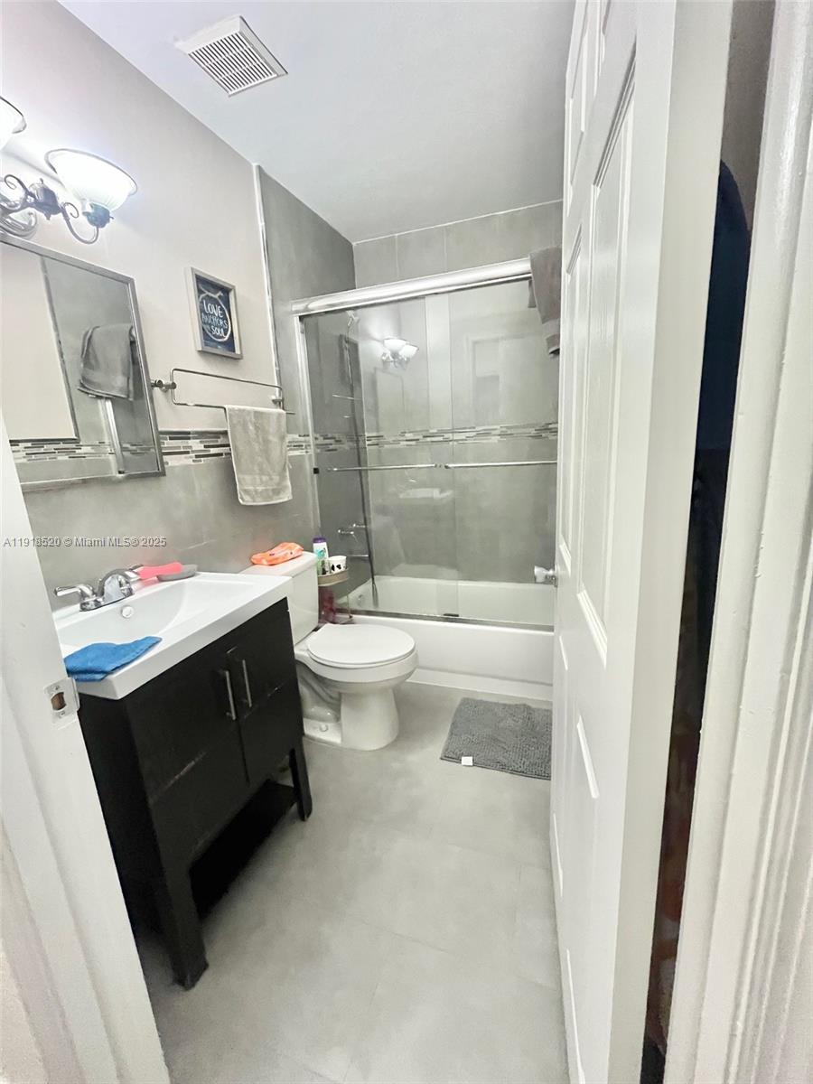 1990 Southwest 121st Court, Unit 232 Miami, FL 33175 - Photo 19 of 28 a bathroom with a sink a toilet and shower