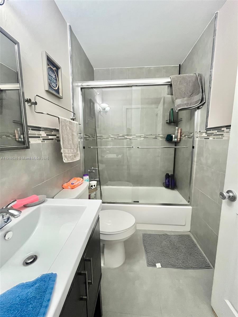 1990 Southwest 121st Court, Unit 232 Miami, FL 33175 - Photo 20 of 28 a bathroom with a sink toilet and shower