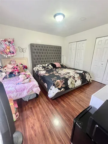 a bedroom with bed and a window