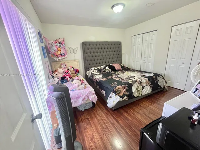 a bedroom with bed and a window