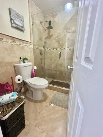 a bathroom with a toilet and a shower