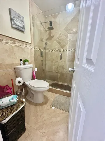 a bathroom with a toilet and a shower