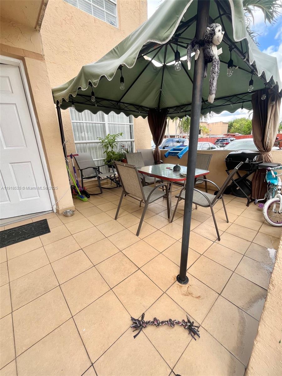 1990 Southwest 121st Court, Unit 232 Miami, FL 33175 - Photo 28 of 28 a view of outdoor space with seating