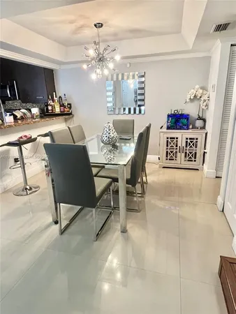 a view of a dining room with furniture and chandelier