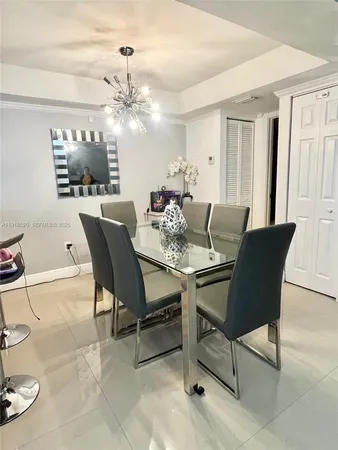 a dining room with furniture and chandelier