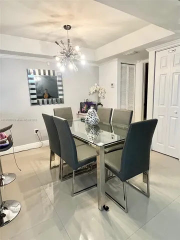a dining room with furniture and chandelier