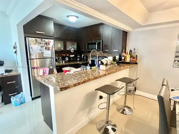 a kitchen with a sink a counter top space and appliances