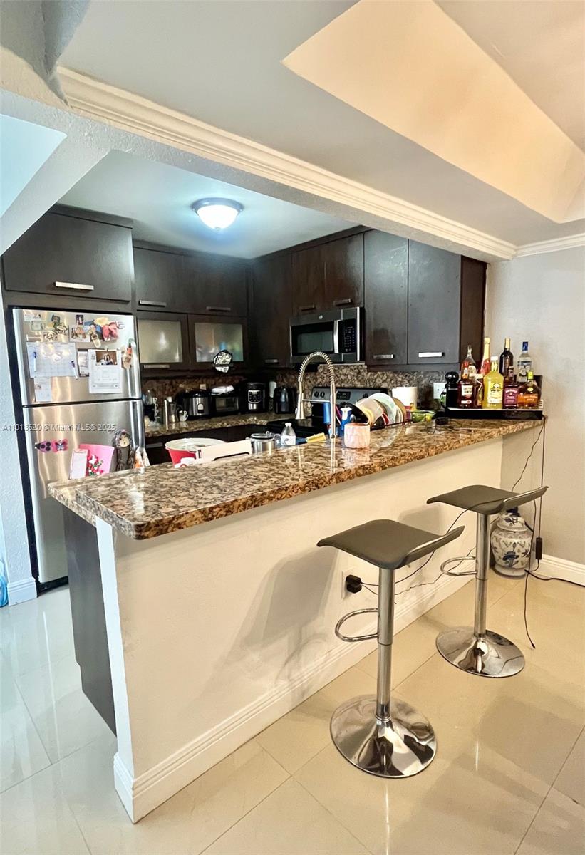 1990 Southwest 121st Court, Unit 232 Miami, FL 33175 - Photo 10 of 28 a kitchen with lots of counter top space and furniture