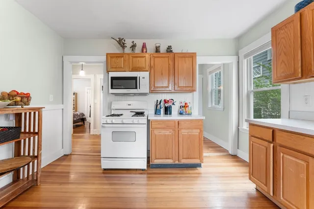 a kitchen with stainless steel appliances granite countertop a stove top oven a sink and a refrigerator