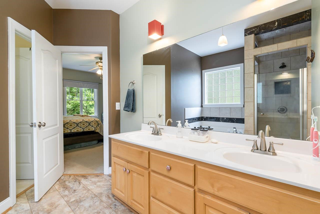 1309 Taylor Farm Road Raleigh, NC 27603 - Photo 15 of 38 Double bowl vanity, new vinyl flooring and walk-in closet Master Bath/Spa