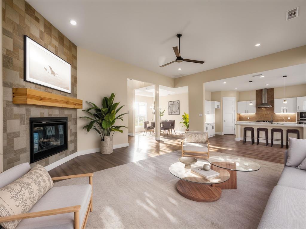 551 North Armstrong Road Venus, TX 76084 - Photo 1 of 1 Staged Living area with dark wood finished floors, a ceiling fan, a tiled fireplace, and recessed lighting