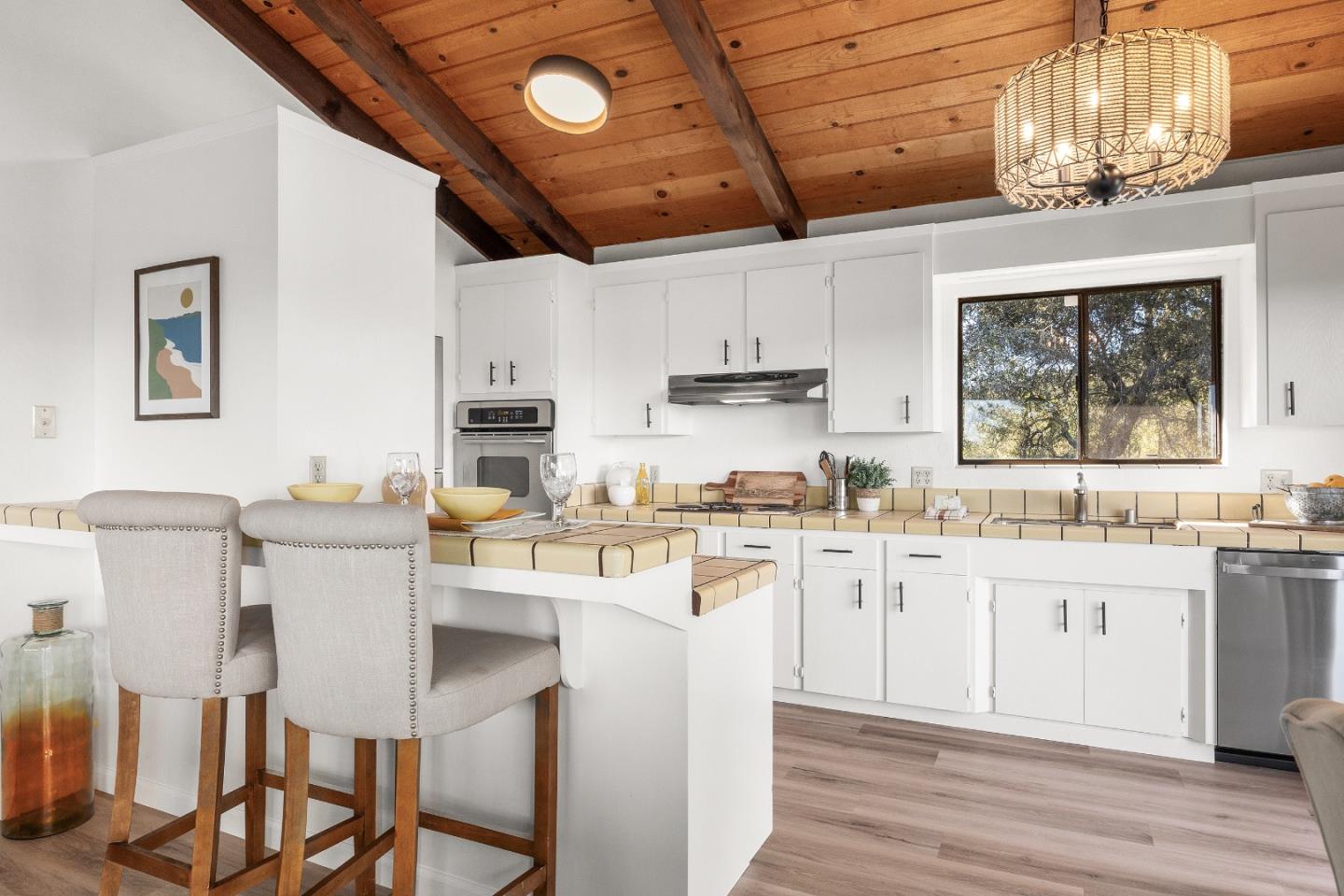1130 Hidden Valley Road Soquel, CA 95073 - Photo 11 of 44 a kitchen with a table chairs refrigerator and cabinets