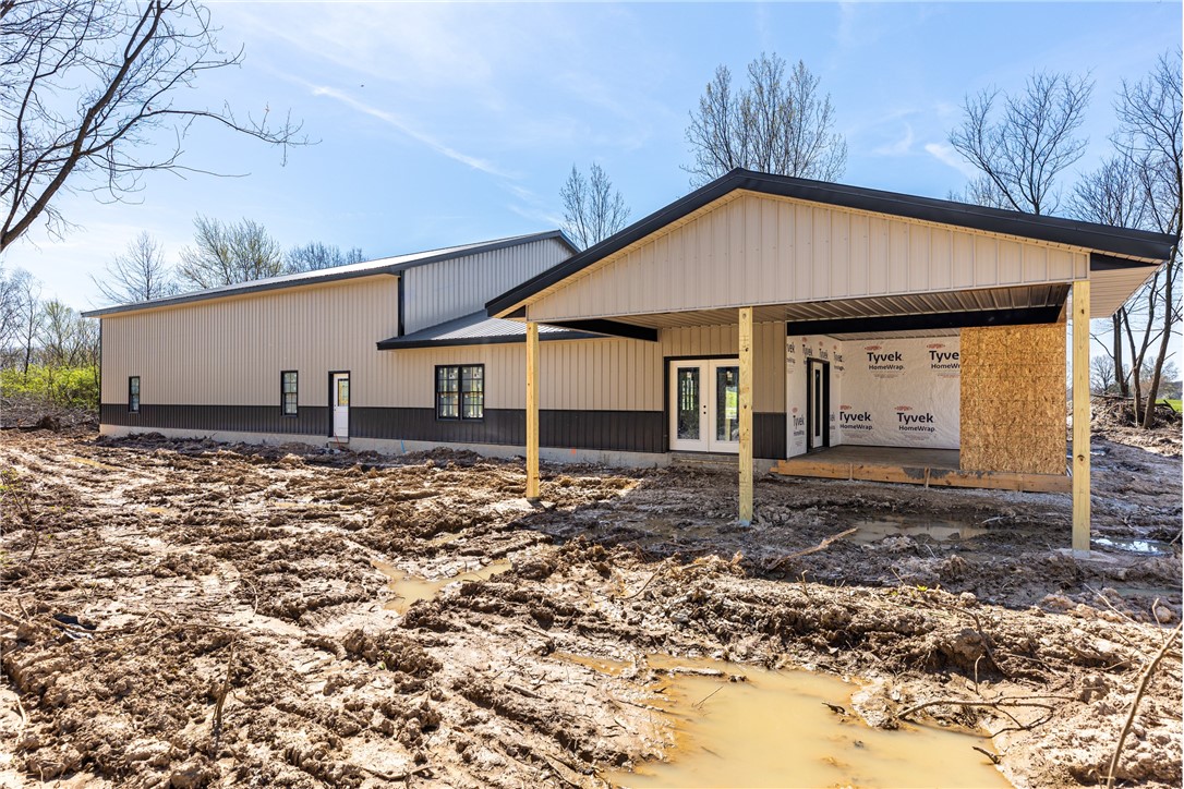 North side of home showing 25x15 covered patio (concrete to still be poured).