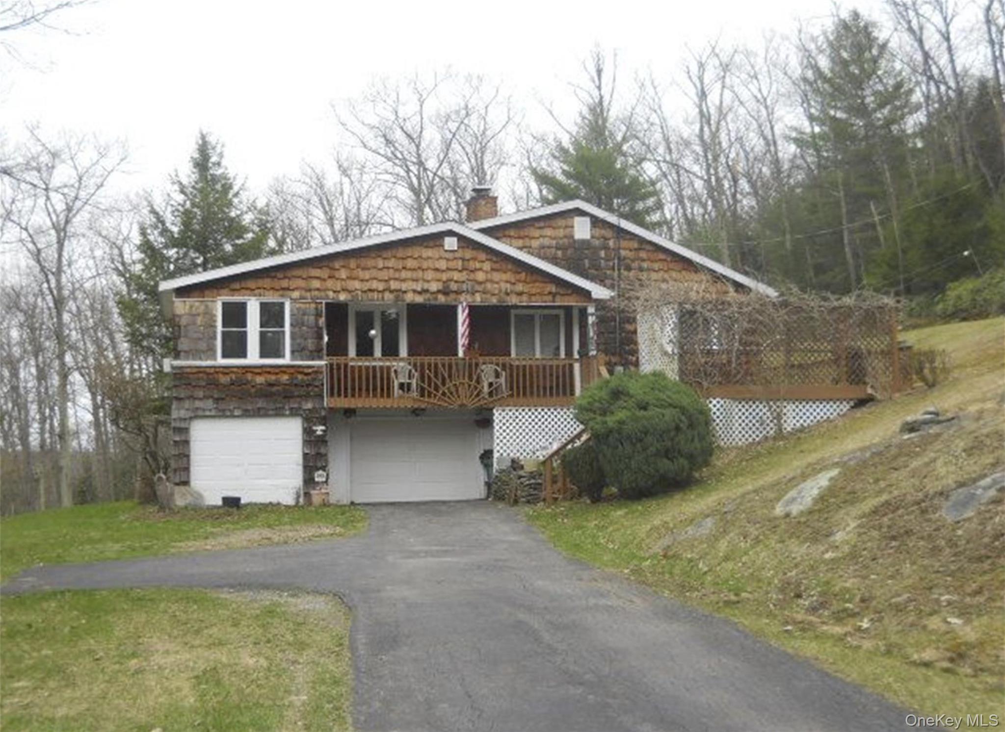 63 Otens Road Ellenville, NY 12428 - Photo 1 of 32 a front view of a house with a yard and garage