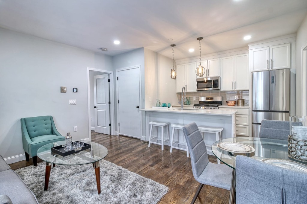 a kitchen with kitchen island a table and chairs