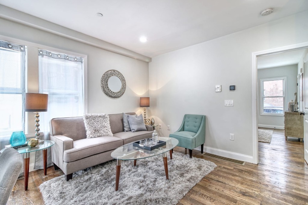 51 Havre Street, Unit 1 Boston, MA 02128 - Photo 2 of 10 a living room with furniture and a wooden floor
