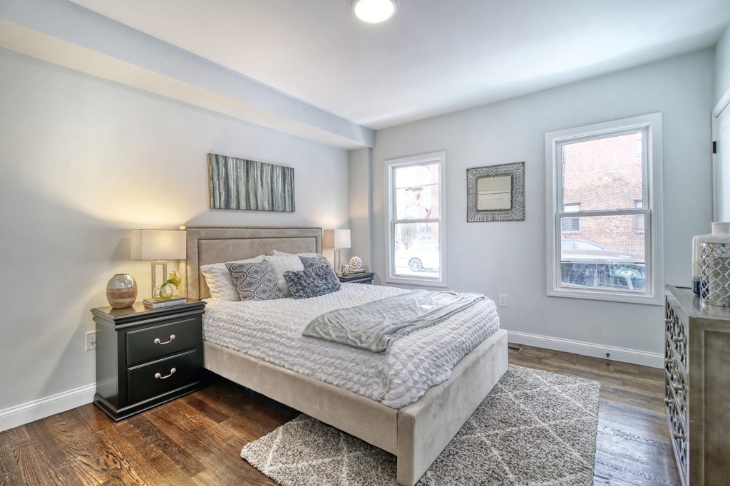 51 Havre Street, Unit 1 Boston, MA 02128 - Photo 3 of 10 a bedroom with a bed and a window