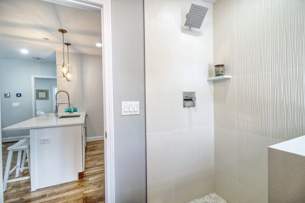 51 Havre Street, Unit 1 Boston, MA 02128 - Photo 4 of 10 a bathroom with a sink a mirror and a shower