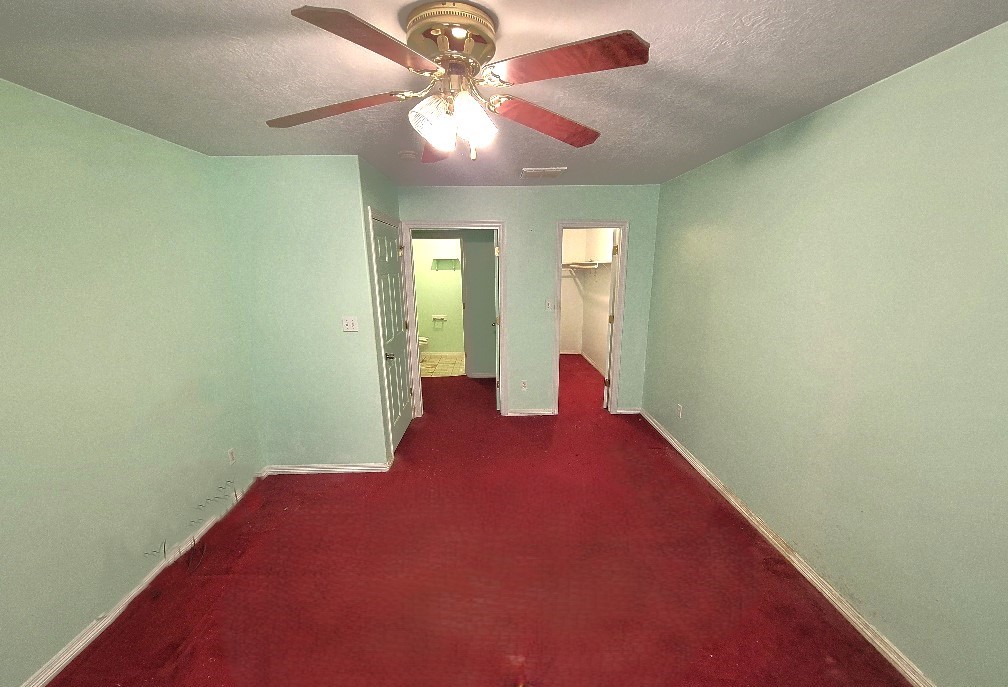 1801 Coe Road Pinehurst, TX 77362 - Photo 11 of 26 en empty room with windows and fan