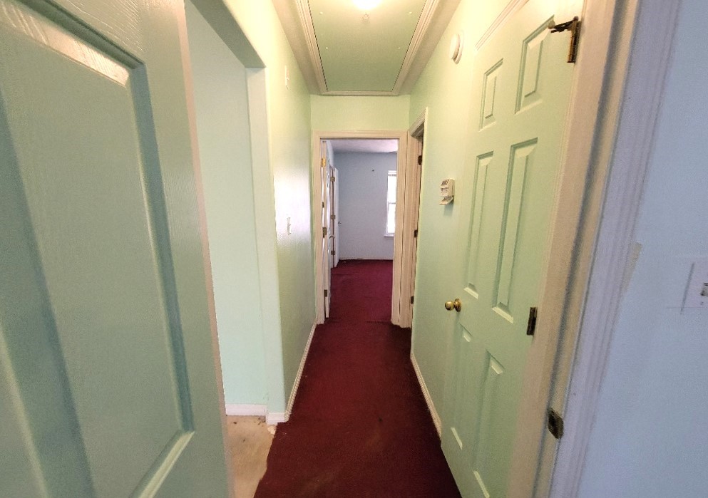 1801 Coe Road Pinehurst, TX 77362 - Photo 17 of 26 a view of a hallway with wooden floor and a glass door
