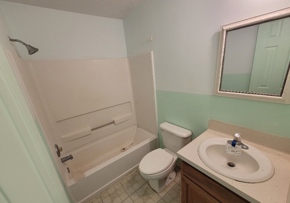 1801 Coe Road Pinehurst, TX 77362 - Photo 18 of 26 a bathroom with a sink toilet and shower