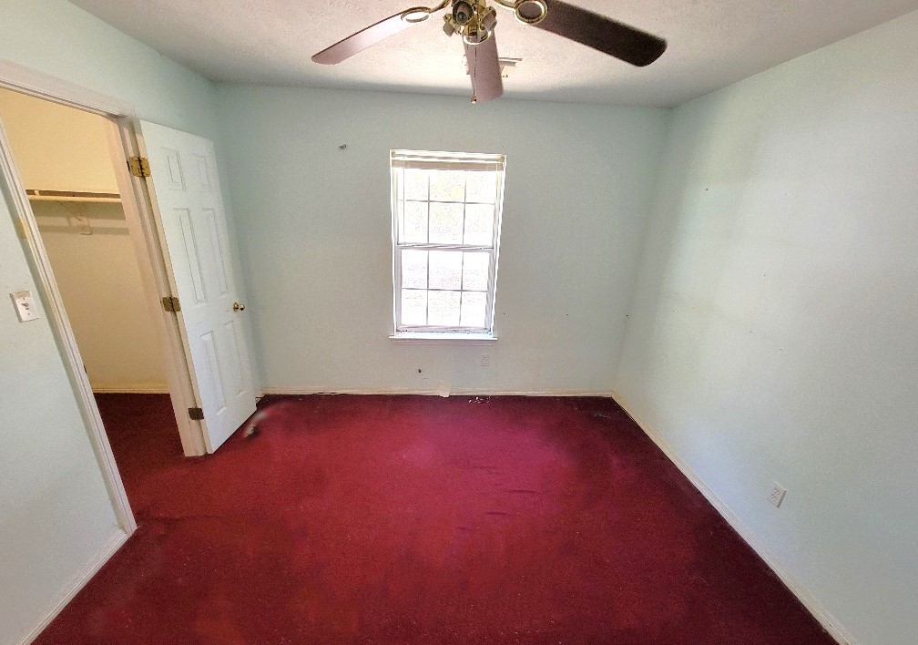 1801 Coe Road Pinehurst, TX 77362 - Photo 19 of 26 an empty room with windows and closet