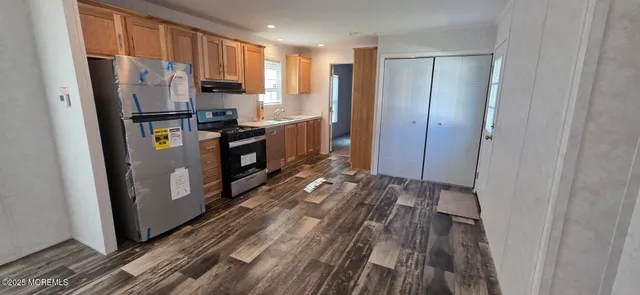 a kitchen with stainless steel appliances granite countertop a refrigerator and a stove