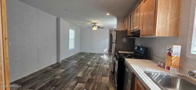 a kitchen with a sink appliances and cabinets