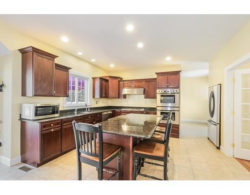 12 Benson Road Rochester, MA 02770 - Photo 8 of 28 a kitchen with stainless steel appliances kitchen island granite countertop a table chairs sink and cabinets