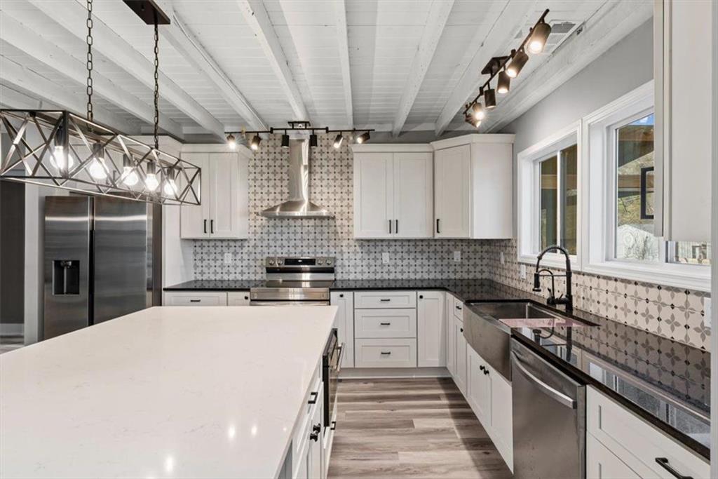 18 Farmer Road Northwest Cartersville, GA 30120 - Photo 13 of 33 a kitchen with stainless steel appliances sink stove microwave and cabinets