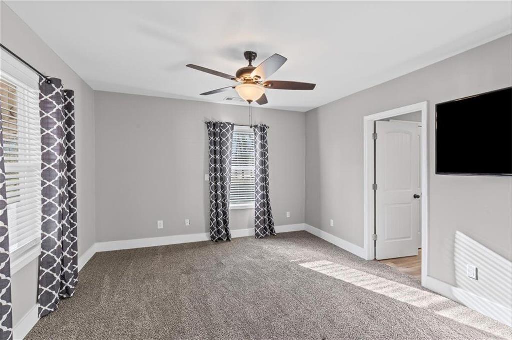 18 Farmer Road Northwest Cartersville, GA 30120 - Photo 15 of 33 a view of an empty room with a ceiling fan and a window