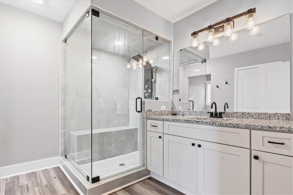 18 Farmer Road Northwest Cartersville, GA 30120 - Photo 16 of 33 a bathroom with a granite countertop sink a mirror and a shower