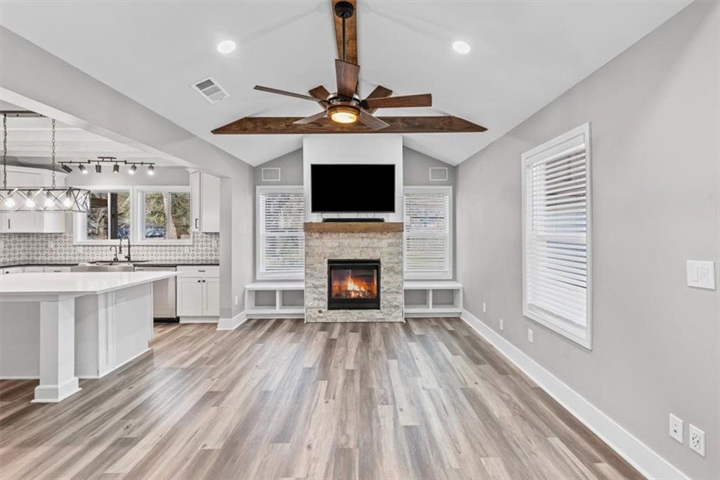 18 Farmer Road Northwest Cartersville, GA 30120 - Photo 7 of 33 a living room with stainless steel appliances furniture a fireplace and a flat screen tv