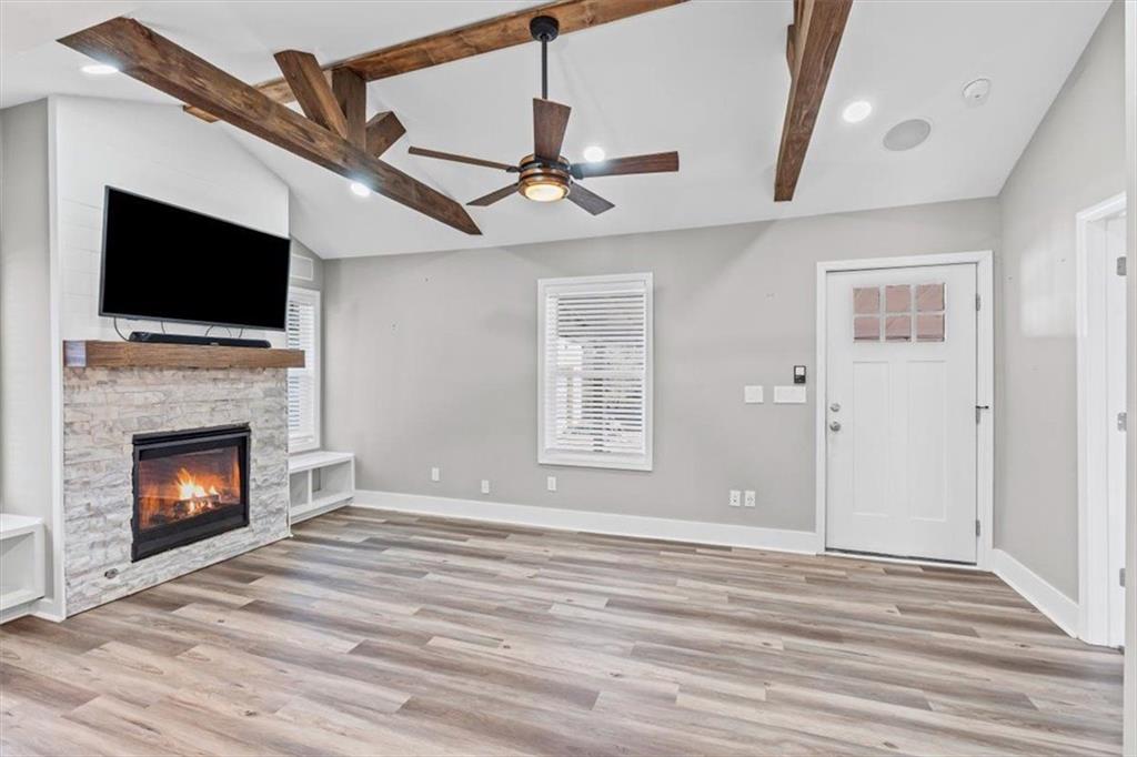18 Farmer Road Northwest Cartersville, GA 30120 - Photo 8 of 33 a view of an empty room with wooden floor fireplace and a window