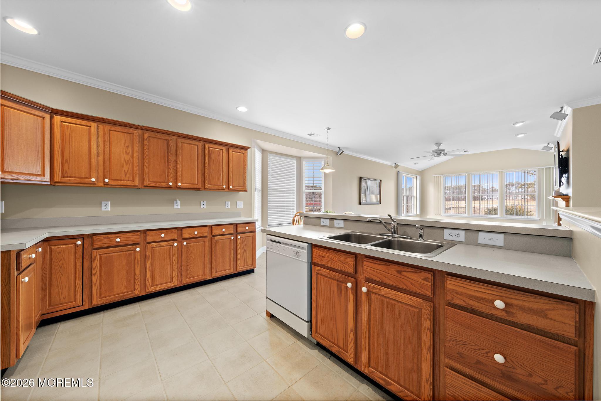 407 Golf View Drive Little Egg Harbor, NJ 08087 - Photo 22 of 58 a kitchen with granite countertop wooden cabinets stainless steel appliances a sink and a window