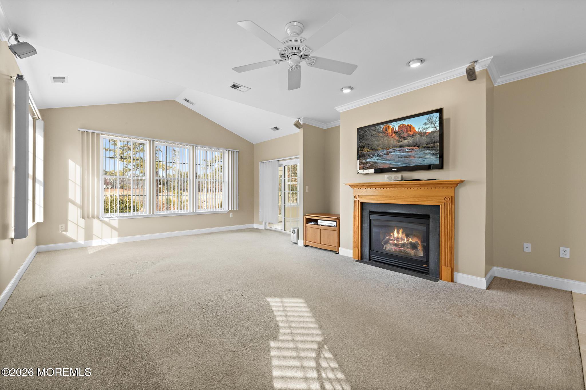 407 Golf View Drive Little Egg Harbor, NJ 08087 - Photo 10 of 58 a view of an empty room with a fireplace and a window