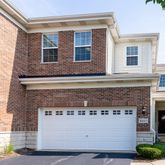 a front view of a building with potted plants