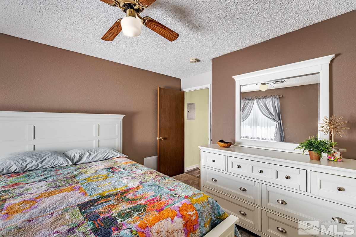 4544 Matich Drive Reno, NV 89502 - Photo 11 of 19 a bedroom with a bed and a dresser