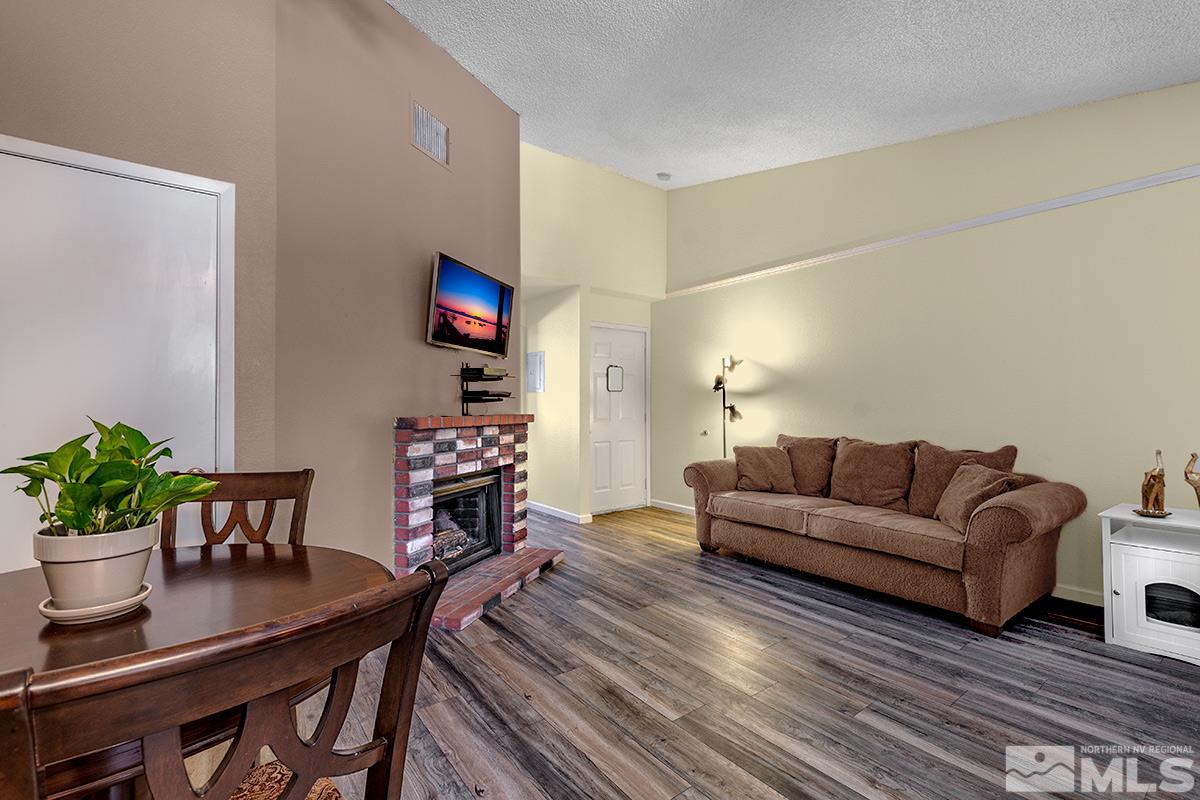 4544 Matich Drive Reno, NV 89502 - Photo 3 of 19 a living room with furniture a potted plant and a table