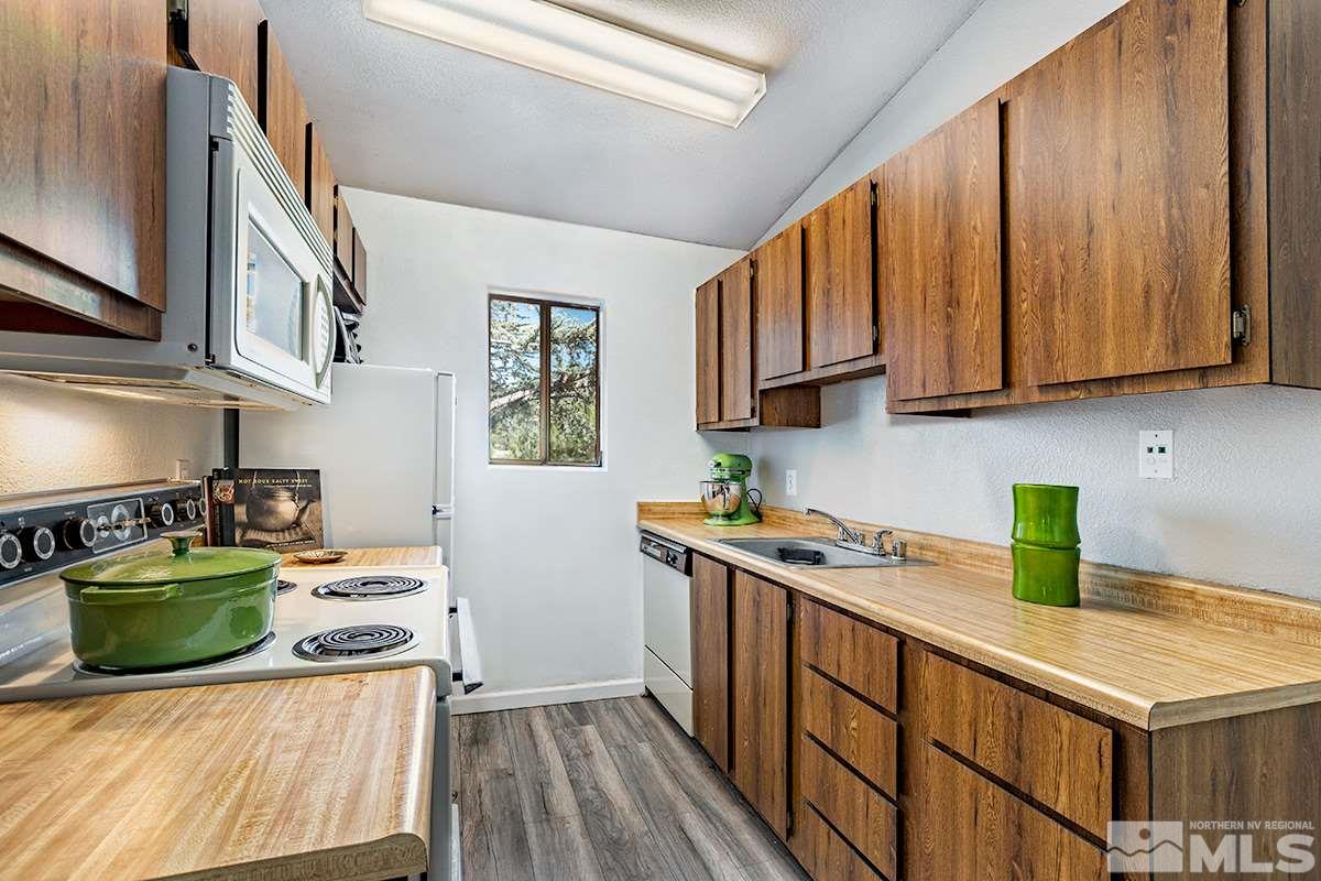 4544 Matich Drive Reno, NV 89502 - Photo 6 of 19 a kitchen with stainless steel appliances granite countertop a sink stove and cabinets