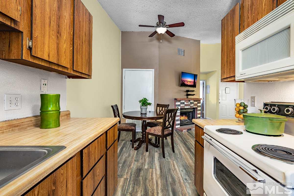 4544 Matich Drive Reno, NV 89502 - Photo 7 of 19 a kitchen with granite countertop lots of counter top space and wooden floor