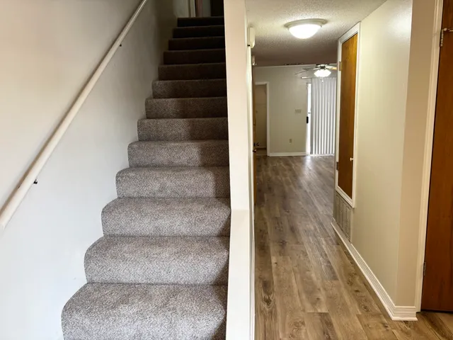 a view of staircase with white walls and windows