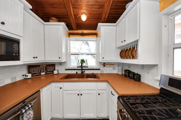 a living room with furniture wooden floor and a floor to ceiling window