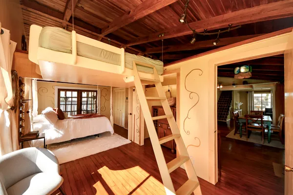 a spacious bedroom with a bed and a window