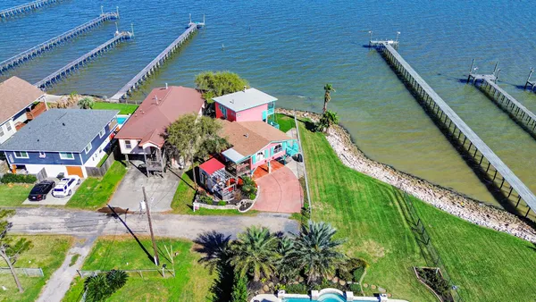 an aerial view of a house with a yard
