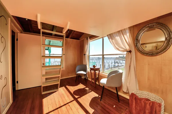 a spacious bedroom with a large bed and a large window