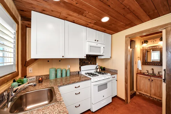 a view of a couches in patio of back yard