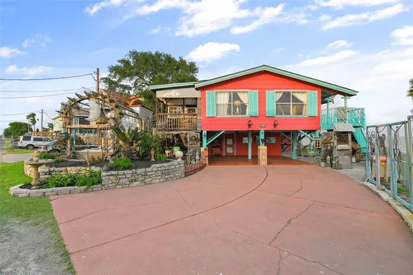 a view of a terrace with furniture and a garden