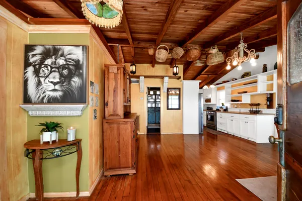 a dining room with furniture a chandelier and wooden floor